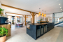 Open plan kitchen/dining/living area with doors to terraces